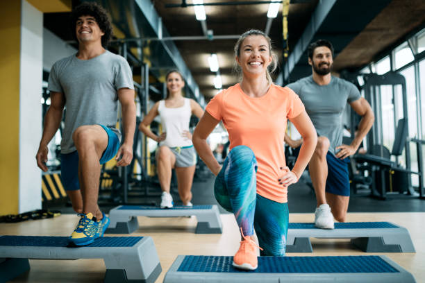 group of young people doing exercises together in gym